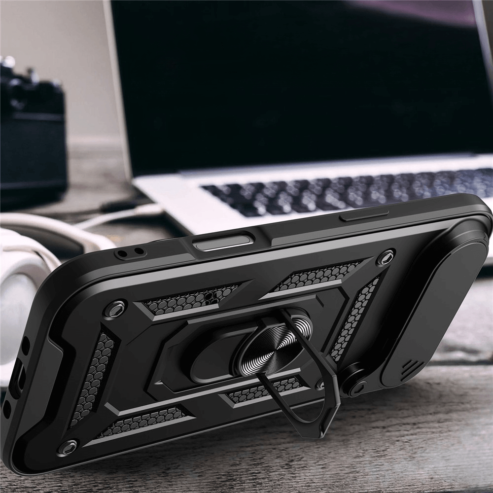Das Cover-Discount iPhone 17 Air - Armor Case mit Kickstand mit Magnethalterung stützt ein iPhone 17 neben einem Laptop und Kopfhörern auf dem Schreibtisch.