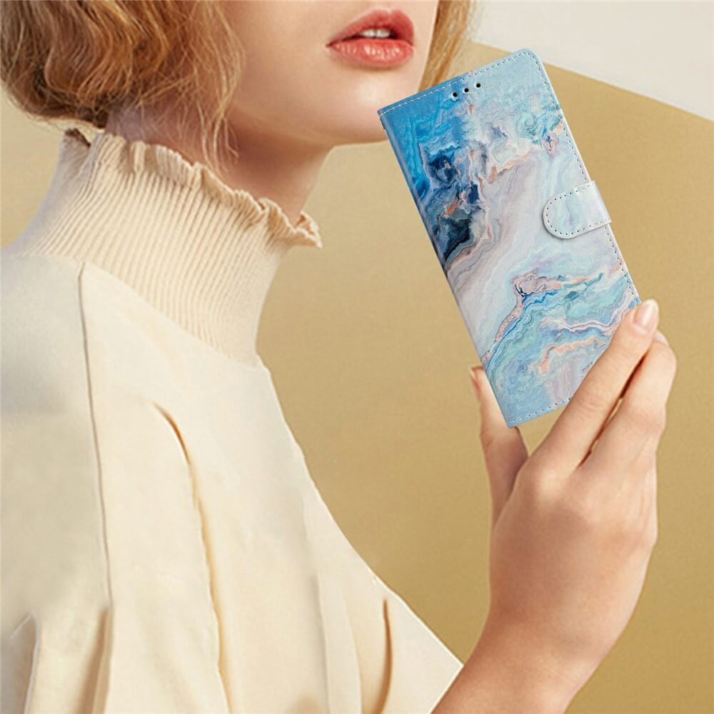 Eine Frau in einem cremefarbenen Rollkragenpullover hält ihr Telefon mit dem Cover-Discount iPhone 17 Pro Max Etui mit Marble Motiv und verleiht ihrem Look einen stilvollen Touch.