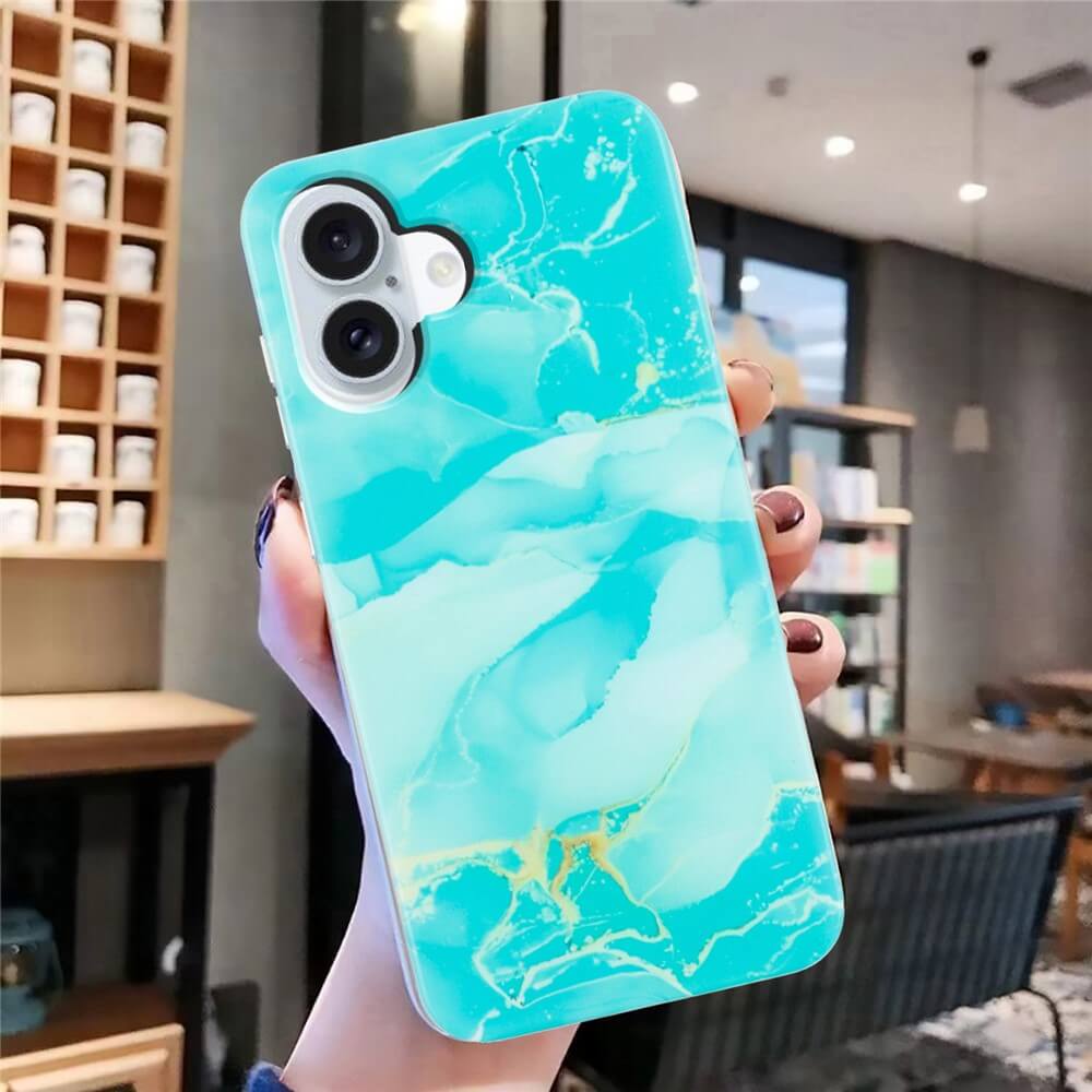 Eine Hand zeigt die Cover-Discount iPhone 17 - Silikon Hülle mit Marble Motiv in Blau und Gold in einem modernen Cafe und hebt den stilvollen Schutz fürs Handy hervor.
