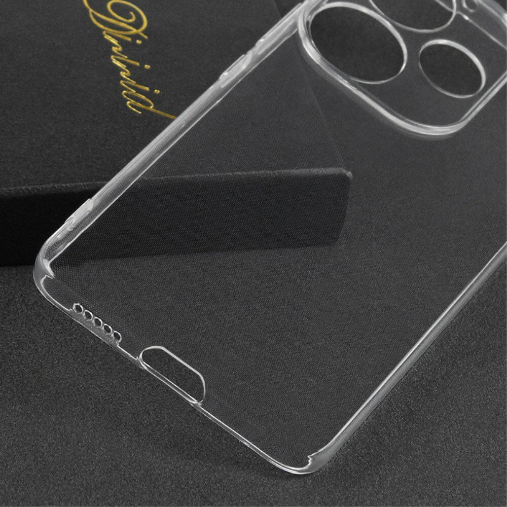 Das Cover-Discount Xiaomi Poco F6 Silikon Gummi Case transparent aus TPU liegt auf dunkler Oberfläche neben schwarzer Box mit goldener Schrift.